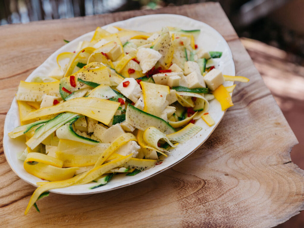 Zucchinis salad with chili and mozzarella on a serving plate
